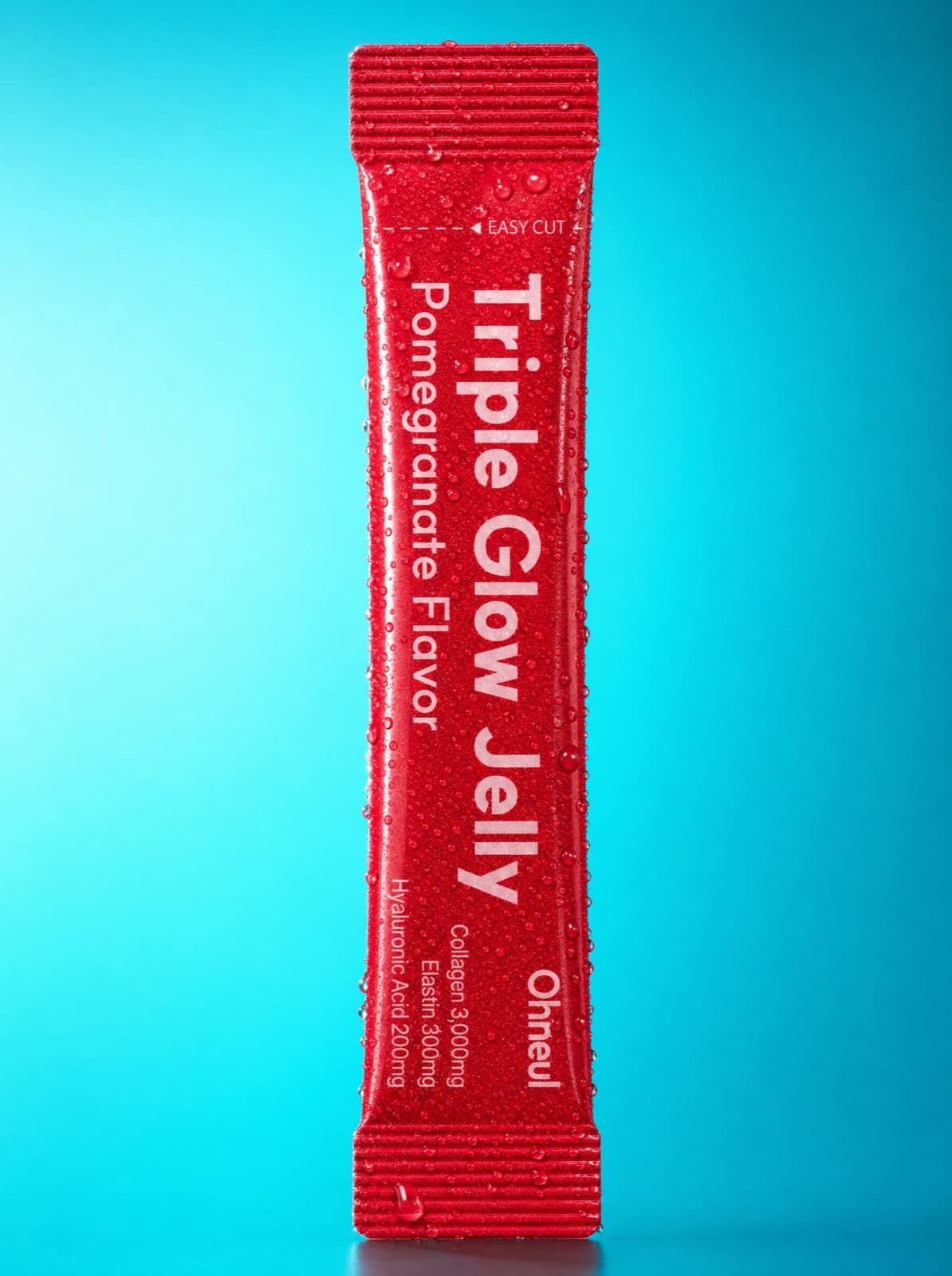 Close-up of a Triple Glow Jelly stick beaded with water droplets on a blue background